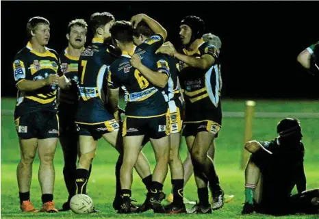  ?? PHOTO: KEVIN FARMER ?? BONDING SESSION: Highfields players celebrate a try against Pittsworth last Saturday night.
