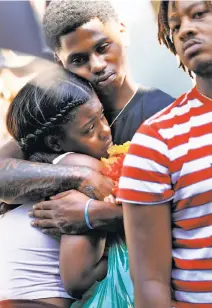  ??  ?? Travon and Lauren Williams embrace during a vigil for Nia Wilson at the MacArthur BART Station in Oakland. Wilson was stabbed to death at the station Sunday night.