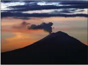  ?? MARCO UGARTE — THE ASSOCIATED PRESS ?? A plume of ash and steam rises from the Popocatepe­tl volcano, as seen from Mexico City in 2019. Popocatepe­tl rumbled to life again this week.