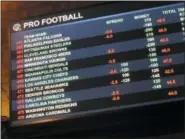  ?? AP PHOTO/WAYNE PARRY ?? This Aug. 1 2018 photo shows a board at Harrah’s casino in Atlantic City, N.J., listing the odds on pro football games in the first week of the NFL season. Resorts casino will begin taking sports bets in person on Wednesday, Aug. 15, becoming the fifth Atlantic City casino to do so.