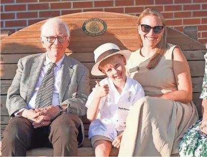  ?? ?? The Stoner family sits on the Nature Sacred bench at the Community Foundation of Greater Des Moines. From left are Tom Stoner; Wyatt Stoner, his grandchild; and Alden Stoner, his daughter, the CEO of Nature Sacred.