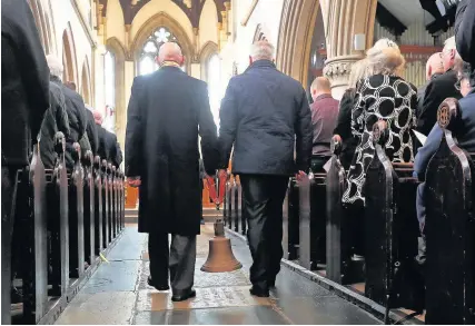  ??  ?? > The bell from The Herald of Free Enterprise is carried into a service at St Mary’s Church in Dover, Kent, yesterday