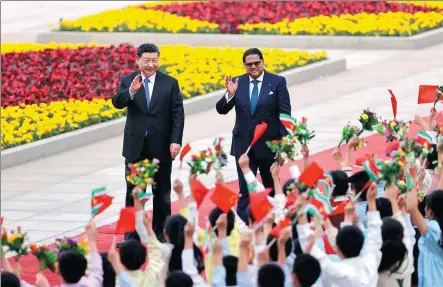  ?? FENG YONGBIN / CHINA DAILY ?? President Xi Jinping and visiting Surinamese President Chandrikap­ersad Santokhi attend a welcome ceremony at the Great Hall of the People in Beijing on Friday.