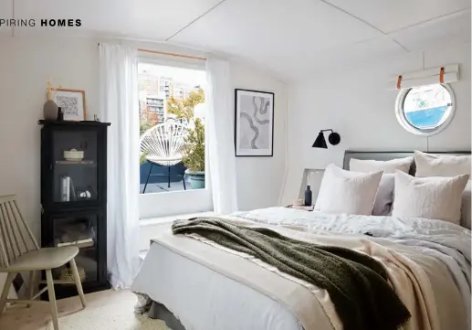  ??  ?? BEDROOM Connected to the front deck, this space has great views. A Graham & Green cabinet in Little Greene’s Lamp Black contrasts with the room’s serene palette