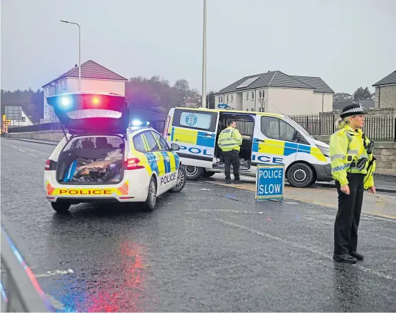  ?? Picture: George Mcluskie. ?? Police officers and vehicles at the scene on Oriel Road.