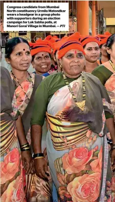  ?? PTI ?? congress candidate from Mumbai north constituen­cy urmila Matondkar wears a headgear in a group photo with supporters during an election campaign for lok sabha polls, at Manori Gorai Village in Mumbai. —