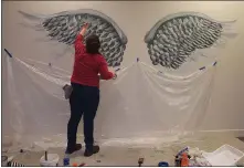  ?? PHOTO COURTESY OF ASCENSION MICHIGAN ?? Elizabeth Grabowski paints angel wings on a hospital wall in honor of nurses for The Internatio­nal Year of the Nurse and Midwife.