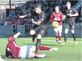  ??  ?? Arbroath’s Bobby Linn is tackled by Stenny’s Morgyn Neill