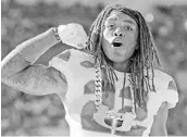  ?? CHARLES TRAINOR JR/TNS ?? Sheldrick Redwine wears the Hurricanes’ Turnover Chain after recovering the ball in a November game.