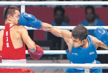  ?? PTI ?? India's Amit Panghal (in blue) in action against Uzbekistan's Hasanboy Dusmatov in men's light flyweight (4649kg) final in Jakarta on Saturday.