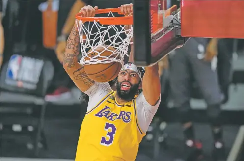  ?? PHOTOS BY MARK J. TERRILL/ASSOCIATED PRESS ?? The Lakers’ Anthony Davis had 34 points on Wednesday against the Heat in Game 1 of the NBA Finals in Lake Buena Vista, Fla.
