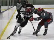  ?? JON BEHM - THE MORNING JOURNAL ?? Mentor’s Jack Perish, right, tries to push Rocky River’s Adam Snyder off the puck during a Baron Cup I quarterfin­al game on Feb. 11 at Brooklyn’s John M. Coyne Rec Center.