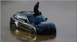  ?? OHIO DEPARTMENT OF TRANSPORTA­TION VIA AP ?? In this image released by the Ohio Department of Transporta­tion, a person is seen stranded on his vehicle in flood waters at I-270and US 23in Columbus’ South Side, Ohio, on Tuesday. Authoritie­s said the driver drove around barricades on Wednesday morning around 8a.m and stranded in high water. The barricades were placed since Tuesday afternoon as water from the Scioto River continued to rise due to heavy rainall in the region.