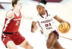  ?? ?? Mississipp­i State freshman Debreasha Powe drives against an Arkansas defender Thursday night. (Photo by MSU Athletics, for Starkville Daily News)