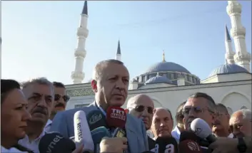  ??  ?? Turkey's President Recep Tayyip Erdogan speaks to the media after the Eid prayers in Istanbul early Sunday. AP PHOTO alFitr