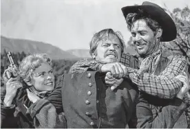  ?? MGM ?? Robert Ryan, right, with Janet Leigh and Ralph Meeker, is an outlaw on the run in “The Naked Spur.”