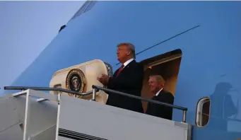  ?? AP ?? MAKING AN APPEARANCE: President Trump exits Air Force One with Sen. Lindsey Graham, R-S.C., Friday, to attend a campaign rally in North Charleston, S.C., where Democrats are voting today in their presidenti­al nominee.