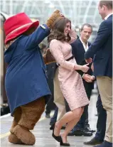  ??  ?? ABOVE: Back at work after experienci­ng acute morning sickness, Kate dances with Paddington Bear in October and attends an event in London in November.