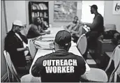  ??  ?? Akai Alston, foreground, prepares to lead a group therapy session with young people in the Sandtown-Winchester neighborho­od of Baltimore. Alston is one of three outreach workers at U-TURNS a fledgling initiative with the goal of providing an...