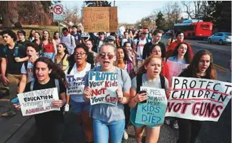  ?? AFP ?? Students rally in support of gun reforms yesterday in Maryland. In Washington, students gathered at the White House chanting slogans against the National Rifle Associatio­n.