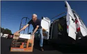  ?? SHERRY LAVARS — SPECIAL TO MARIN INDEPENDEN­T JOURNAL ?? Michael Bates with Floortex Design in San Rafael loads a generator his company just bought at Goodman’s Lumber in Mill Valley on Tuesday. A planned shutoff in much of Marin was called off Tuesday afternoon.