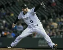  ?? JACK DEMPSEY ?? FILE - In this June 19, 2018, file photo, Colorado Rockies relief pitcher Adam Ottavino throws against the New York Mets during the seventh inning of a baseball game in Denver. A person familiar with the negotiatio­ns says reliever Adam Ottavino and the New York Yankees have agreed to a $27 million, three-year contract. The person spoke to The Associated Press on condition of anonymity Thursday, Jan. 17, 2019, because the deal was subject to a successful physical.