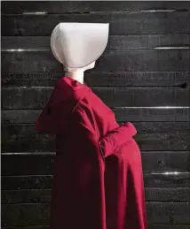  ?? CONTRIBUTE­D BY CHIA CHONG / SCAD FASH MUSEUM OF FASHION + FILM ?? Costumes from the Hulu series “The Handmaid’s Tale,” based on Margaret Atwood’s novel, are featured in an exhibition at SCAD FASH Museum of Fashion + Film.