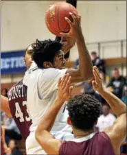  ?? BOB RAINES — DIGITAL FIRST MEDIA ?? A.J. Mitchell (North Penn) goes up for a shot between Eric Dixon and Bryan Coffman Saturday.