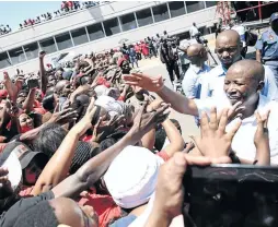  ?? / THULI DLAMINI ?? EFF leader Julius Malema greets his supporters outside the Newcastle magistrate’s court yesterday.