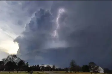  ?? RON JOHNSON — JOURNAL STAR VIA AP ?? Lightning flashes in storm clouds over the village of Dunlap, Ill., Tuesday. A spring-like storm churning across the Midwest poses a risk of more bad weather for millions of people.