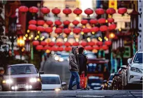  ?? Carlos Avila Gonzalez/The Chronicle ?? Pedestrian­s walk in San Francisco’s Chinatown, the largest community of its type in the nation. Chinatown has been in recovery mode since the pandemic.