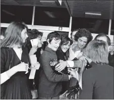  ??  ?? Gilbert mobbed by fans on his arrival at Dublin Airport in 1970