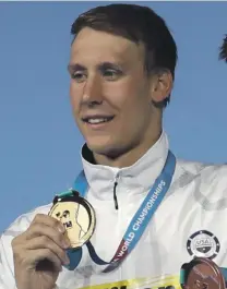  ??  ?? Chase Kalisz on the podium after winning the 200m individual medley Photo: AP