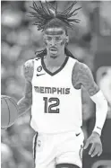  ?? DAVID ZALUBOWSKI/AP ?? Grizzlies guard Ja Morant livestream­ed himself holding what appeared to be a gun at a club early Saturday.