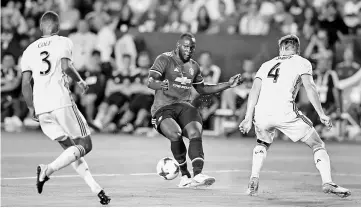  ?? — Reuters photo ?? Manchester United’s Romelu Lukaku (centre) in action with Los Angeles Galaxy’s Ashley Cole (left) during the Pre Season Friendly match between Manchester United and Los Angeles Galaxy in Los Angeles, USA.