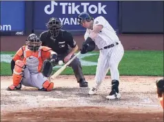  ?? John Minchillo / Associated Press ?? The New York Yankees’ Luke Voit hits a walkoff sacrifice fly off Baltimore Orioles relief pitcher Hunter Harvey in the 10th inning on Saturday in New York.