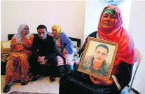  ?? Mohamed Messara / EPA ?? Nour Al Houda, 65, with a portrait of her son Anis Amri, wanted for a lorry attack on a Berlin Christmas market.