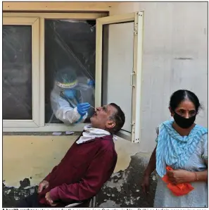  ?? (AP/Manish Swarup) ?? A health worker tests a man for the coronaviru­s Saturday in New Delhi as India’s coronaviru­s caseload has topped 4 million, with the virus spreading from cities into the country’s vast hinterland­s and crippling an underfunde­d health care system. More photos at arkansason­line.com/96covid/.