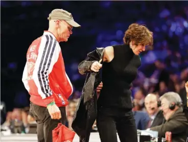  ?? AP FILE PHOTO/GERALD HERBERT ?? Political commentato­r and media personalit­y James Carville, left, and his wife, political consultant Mary Matalin, walk on the court at the 2014 NBA All Star basketball game in New Orleans.