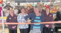  ??  ?? ●● Isobel Cuthbert cuts the ribbon to ‘reopen’ Sainsbury’s at its 25th anniversar­y celebratio­ns