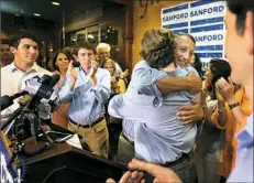  ?? Wade Spees/The Post And Courier via AP ?? U.S. Rep. Mark Sanford hugged his sons after addressing supporters at Liberty Tap Room in Mount Pleasant, S.C., on Monday.