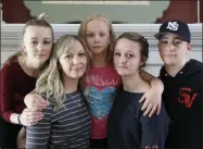  ?? TED S. WARREN - ASSOCIATED PRESS ?? In this Oct. 9photo, Donya Grant, second from left, poses for a photo with her children, Rowyn, 11, left, Mabry, 8, center, Hadley, 16, second from right, and Kemper, 14, right, in their home in Monroe, Wash. The family joined a lawsuit against the Monroe School District and others, alleging that the district failed to adequately respond to PCBs, or polychlori­nated biphenyls, at the Sky Valley Education Center, a K-12public school. Grant has homeschool­ed her children since they left Sky Valley in 2016for health reasons that they believe were related to the toxic chemicals.