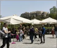  ?? YORGOS KARAHALIS — THE ASSOCIATED PRESS ?? People make their way on a pedestrian street at the foot of the Acropolis hill in Athens on Sunday.