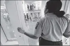  ?? KENT D. JOHNSON / KDJOHNSON@AJC.COM ?? Officer Niasha Cooper watches inmates through an open cellblock door at the Fulton County Jail. The Rice Street jail seeks to come out from under federal oversight by the end of the year.