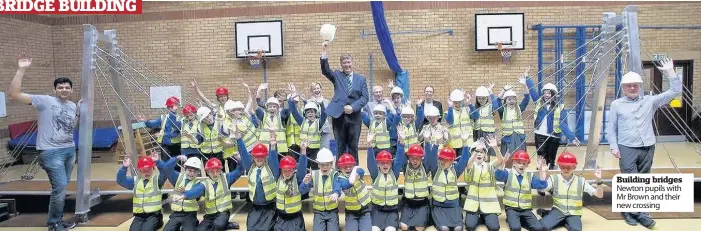  ??  ?? Building bridges Newton pupils with Mr Brown and their new crossing