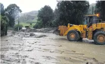  ?? PHOTO: TOM KITCHIN ?? Work continued to clear SH8 through Roxburgh yesterday.