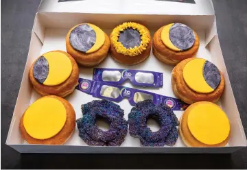  ?? (Travel Butler County/RVP Photograph­y via AP) ?? A box of donuts arranged to represent phases of an eclipse is displayed at the Donut Dude shop Frida in Liberty Township, Ohio. Businesses are capitalizi­ng on the April 8 solar eclipse expected to dim skies across a generous stretch of North America.