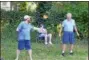  ??  ?? Jugglers entertain the hundreds who attended the Great American Solar Eclipse viewing party at the future site of the Oneida Public Library on Monday.