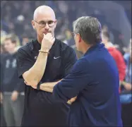  ?? Jessica Hill / Associated Press ?? UConn men’s basketball coach Dan Hurley, left, talks with women’s coach Geno Auriemma during UConn’s annual First Night celebratio­n in Storrs in 2019.