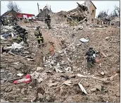  ?? ?? Blitzed...searching debris in Zaporizhzh­ia